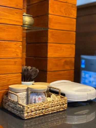 a wicker basket with dishes and a toilet on a table at Rengganis Homestay in Yogyakarta