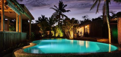 a swimming pool in front of a house at night at Pousada San Antonio Praia in Caraíva