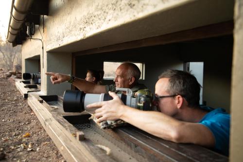 a man with a camera and a man pointing at a camera at Antares Bush Camp & Umgede Hide in Grietjie Nature Reserve