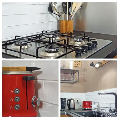 a stove top in a kitchen with a red appliance at Le calme à 5 mn du centre ville - La Lisière T2 in Bonneville