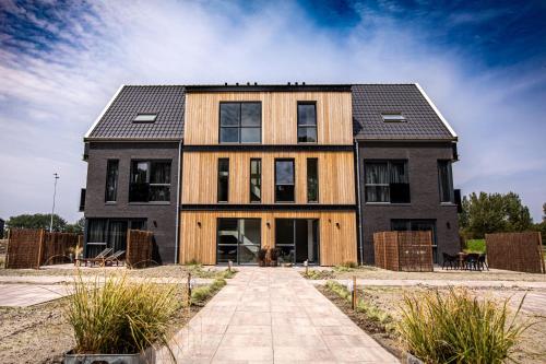 una casa con fachada de madera y negro en Domburg Holiday Resort en Domburg