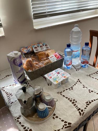 a table with a box of pastries and bottles of water at L’Ulivo in Formia