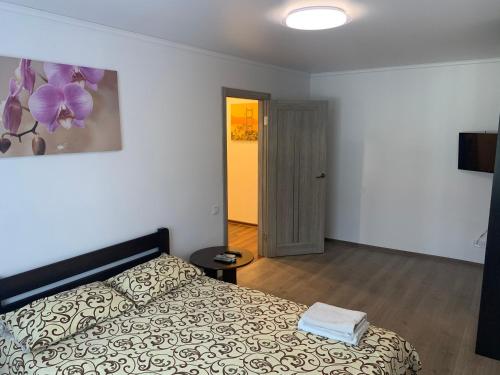 a bedroom with a bed and a door to a hallway at Апартаменты метро Тараса Шевченко in Kyiv