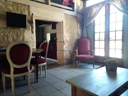 尚尼耶的住宿－Gites les Lignons，一间带椅子和桌子的房间以及一台电视