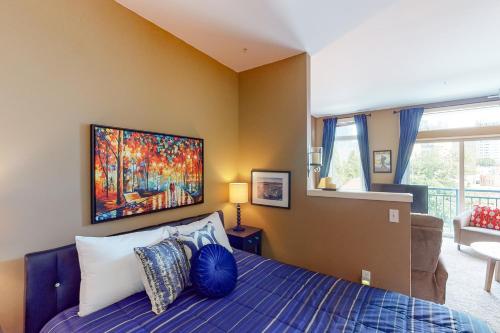 a bedroom with a bed with a painting on the wall at Belltown Court II in Seattle