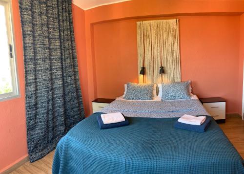 a bedroom with a bed with two towels on it at Santa Ana in Casas Devesa