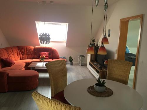 a living room with a couch and a table at Am Anker in Langballig