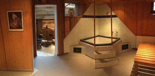 a room with a staircase with a glass table at Gästehaus Hartweger in Haus im Ennstal