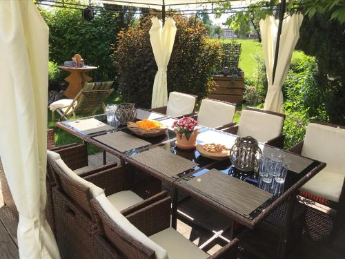 a dining table and chairs on a patio at Die Dirndlkönigin in Grünenbach