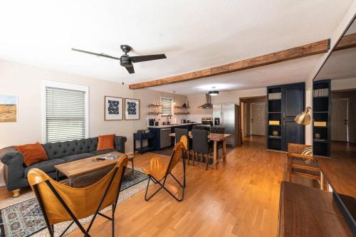 a living room with a couch and a table at Escape to a Restored 1920s East Waco Bungalow in Waco