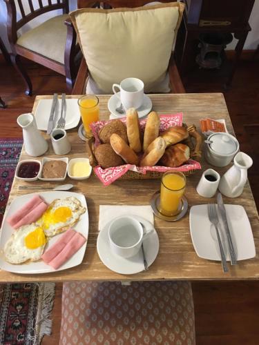 a table with a breakfast of eggs and bread at Casablanca Hotel Boutique in Lima