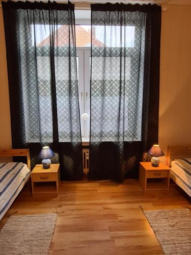 a room with two beds and a large window at Bei Chogman in Gronau