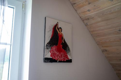 a picture of a woman in a red dress on a wall at bizon in Sadowne