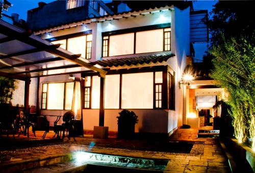 a house with a pool in front of it at night at Hotel Casona Usaquen in Bogotá