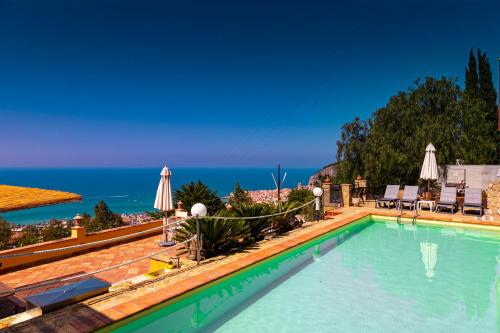 a swimming pool with a view of the ocean at Residence Agape in Cefalù
