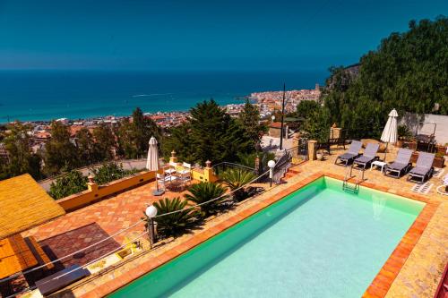 a swimming pool with a view of the ocean at Residence Agape in Cefalù