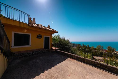 a house with a balcony with a view of the ocean at Residence Agape in Cefalù
