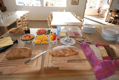 a table with different types of bread and other foods at Álftröð Guesthouse in Brautarholt