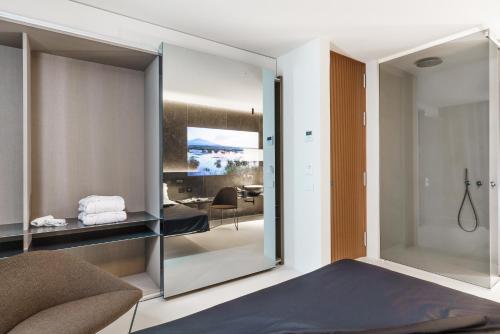 a bedroom with a sliding glass door leading to a dining room at Meo Design Suites & Spa in Catania