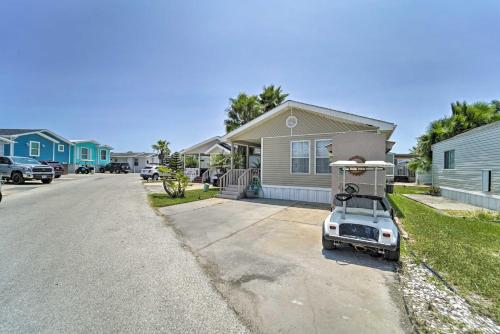 a golf cart parked in front of a house at Deck and Pool Access Long Island Village Escape! in Port Isabel