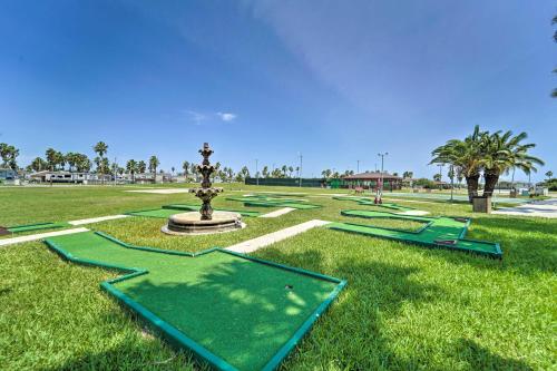 a fountain in the middle of a park with green grass at Deck and Pool Access Long Island Village Escape! in Port Isabel
