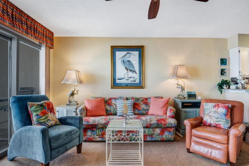 a living room with a couch and two chairs at Crystal Sands III in Destin