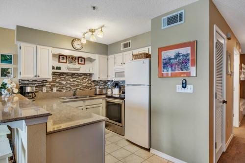 a kitchen with white appliances and a white refrigerator at Crystal Sands III in Destin
