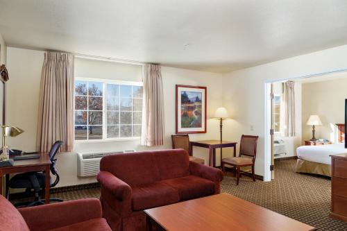 Habitación de hotel con cama y sala de estar. en Comfort Inn & Suites, en Susanville