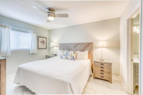 a white bedroom with a bed and a window at Windancer Condominiums in Destin