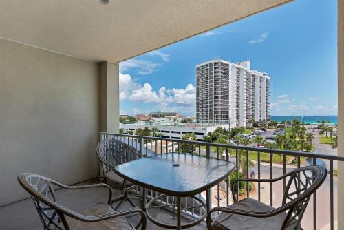 a balcony with a table and chairs and a view of the ocean at Ariel Dunes I in Destin