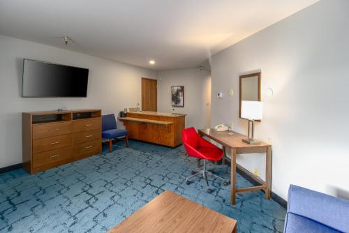 a hotel room with a desk and a television at Red Lion Templin's Hotel on the River in Post Falls