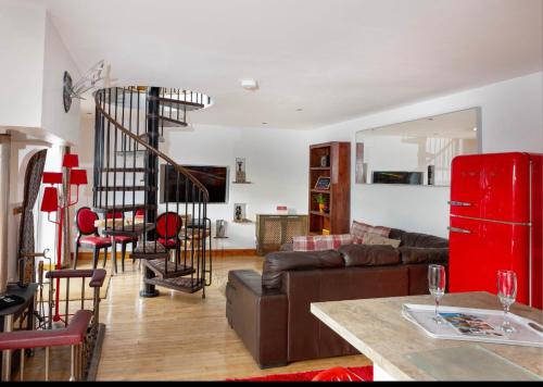 a living room with a couch and a spiral staircase at Lincoln Holiday Retreat View with Private Hot Tub in Lincoln