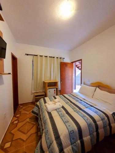 Ένα ή περισσότερα κρεβάτια σε δωμάτιο στο Pousada Capim Dourado