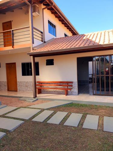 a house with a porch and a balcony at Pousada Capim Dourado in Alto Paraíso de Goiás