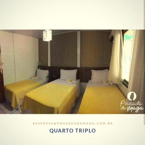 two beds in a room with yellow sheets at Pousada da Maga in Fernando de Noronha
