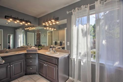 a bathroom with a sink and a large mirror at Pet-Friendly Home with Grill, 2 Mi to Autzen Stadium! in Springfield