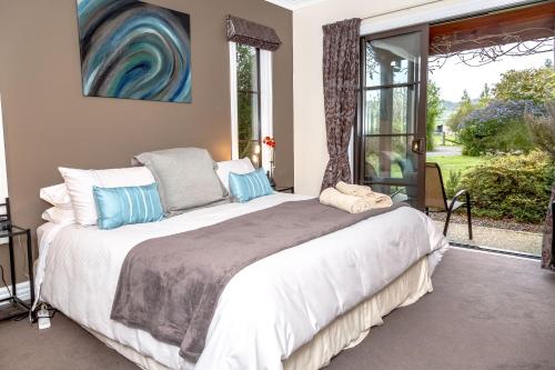um quarto com uma cama grande e uma janela em The Summit Lodge em Gladstone