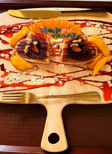 a wooden cutting board with two slices of food on it at A Villas Resort & Restaurant in Zamboanguita