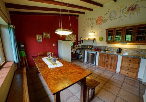 a kitchen with a wooden table in the middle at Finca La Vispera in Samaipata