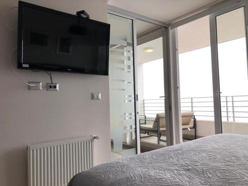 TV in/ali zabaviščno središče v nastanitvi Apartamento Piso 19 Reñaca Vista al Mar