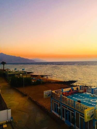 a view of a beach with a pool and the ocean at Diamond Dahab House in Dahab