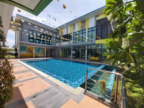 a swimming pool in front of a building at Bed in Beyt Boutique Hotel in Nonthaburi