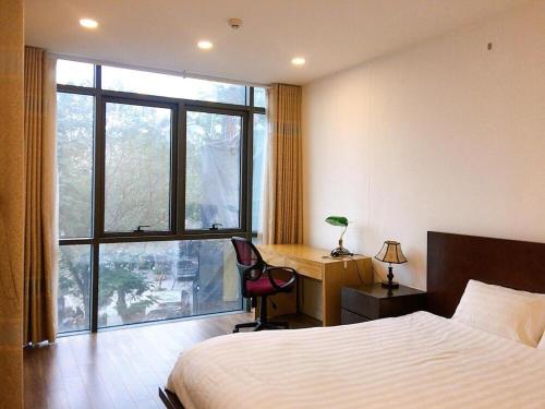 Tài Tâm - Grand Spring Suites tesisinde bir odada yatak veya yataklar