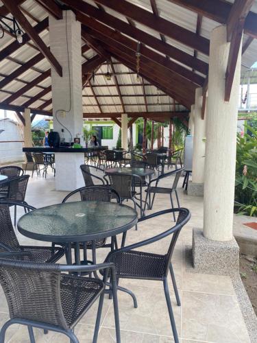 a row of tables and chairs under a roof at HV Sueño Real Tatacoa in Villavieja