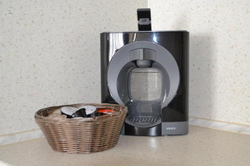 a coffee maker and a basket on a counter at Apartment on the Cliff Obzor in Obzor