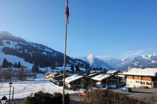 a view of a ski resort with snow covered mountains at Chalet Mutzli in Gstaad