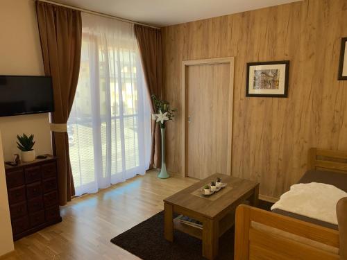 a living room with a bed and a coffee table at Apartmany Arber in Železná Ruda