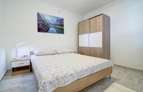 a bedroom with a large bed and a wooden cabinet at Nehaj in Senj