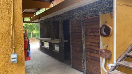 a side of a building with a wooden wall at HOSTAL CASA DEL ANGEL in Mazunte