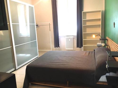 a bedroom with a bed and a large window at Pigafetta n 52 in Turin